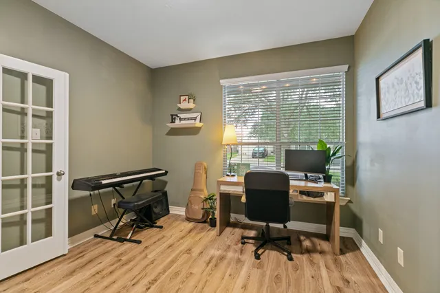 a view of a workspace with furniture and a window