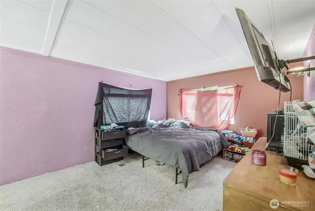 a bedroom with furniture and a window