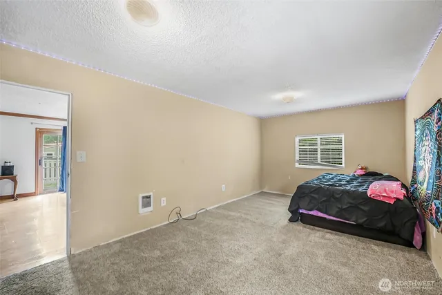 a living room with a bed furniture and a window