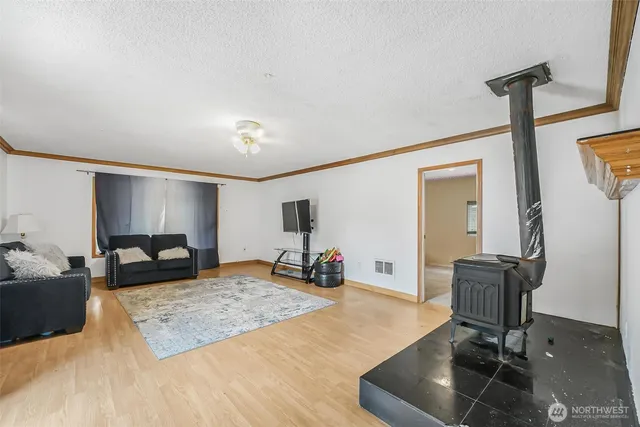 a bedroom with a bed a table and a dresser