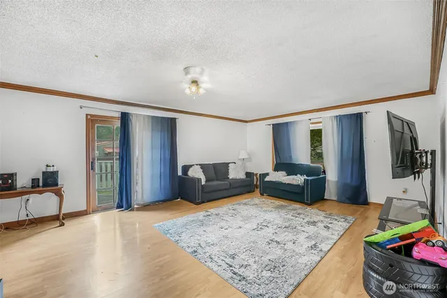 a bedroom with furniture and a flat screen tv
