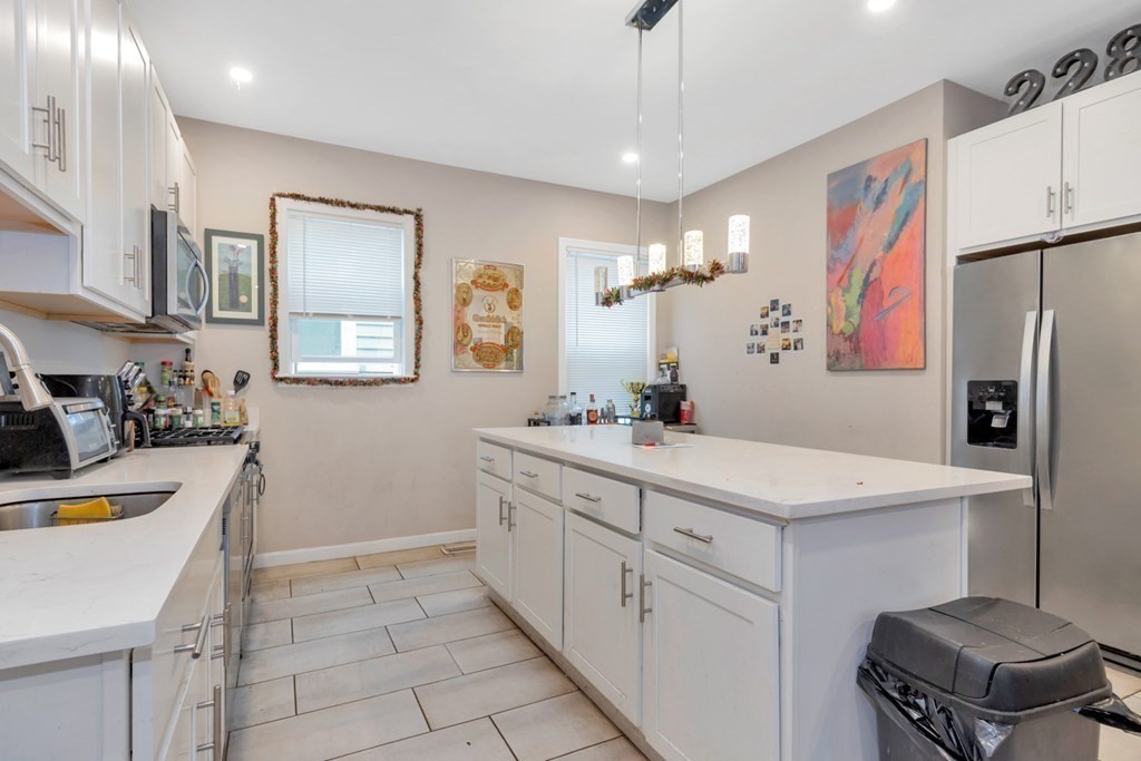 228 Calumet Street, Unit 1 Boston, MA 02120 - Photo 4 of 14 a bathroom with a sink a mirror and a toilet