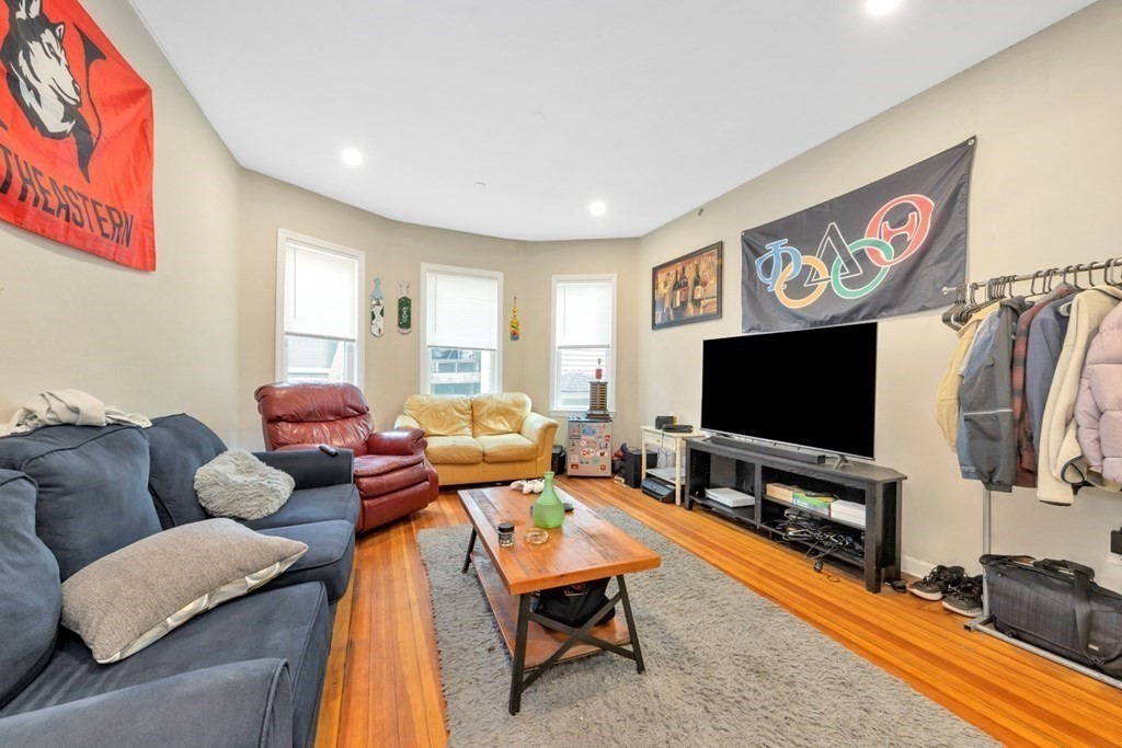 228 Calumet Street, Unit 1 Boston, MA 02120 - Photo 5 of 14 a living room with furniture and a flat screen tv