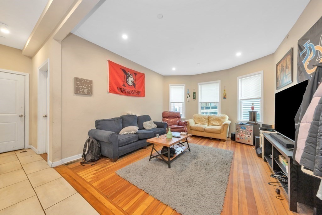 228 Calumet Street, Unit 1 Boston, MA 02120 - Photo 6 of 14 a living room with furniture and a flat screen tv