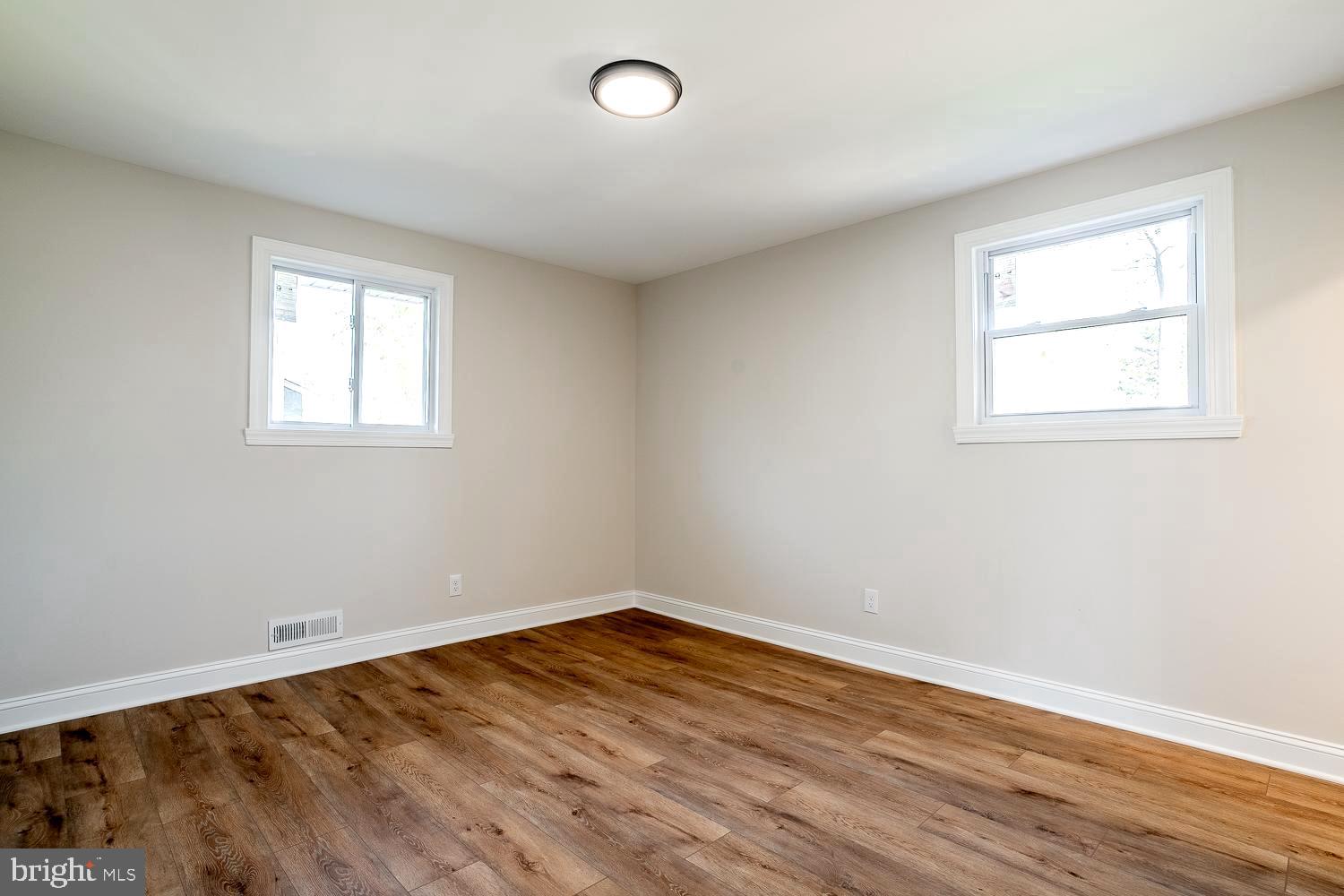 1009 Edgemoor Road Cherry Hill, NJ 08034 - Photo 27 of 49 an empty room with wooden floor and windows