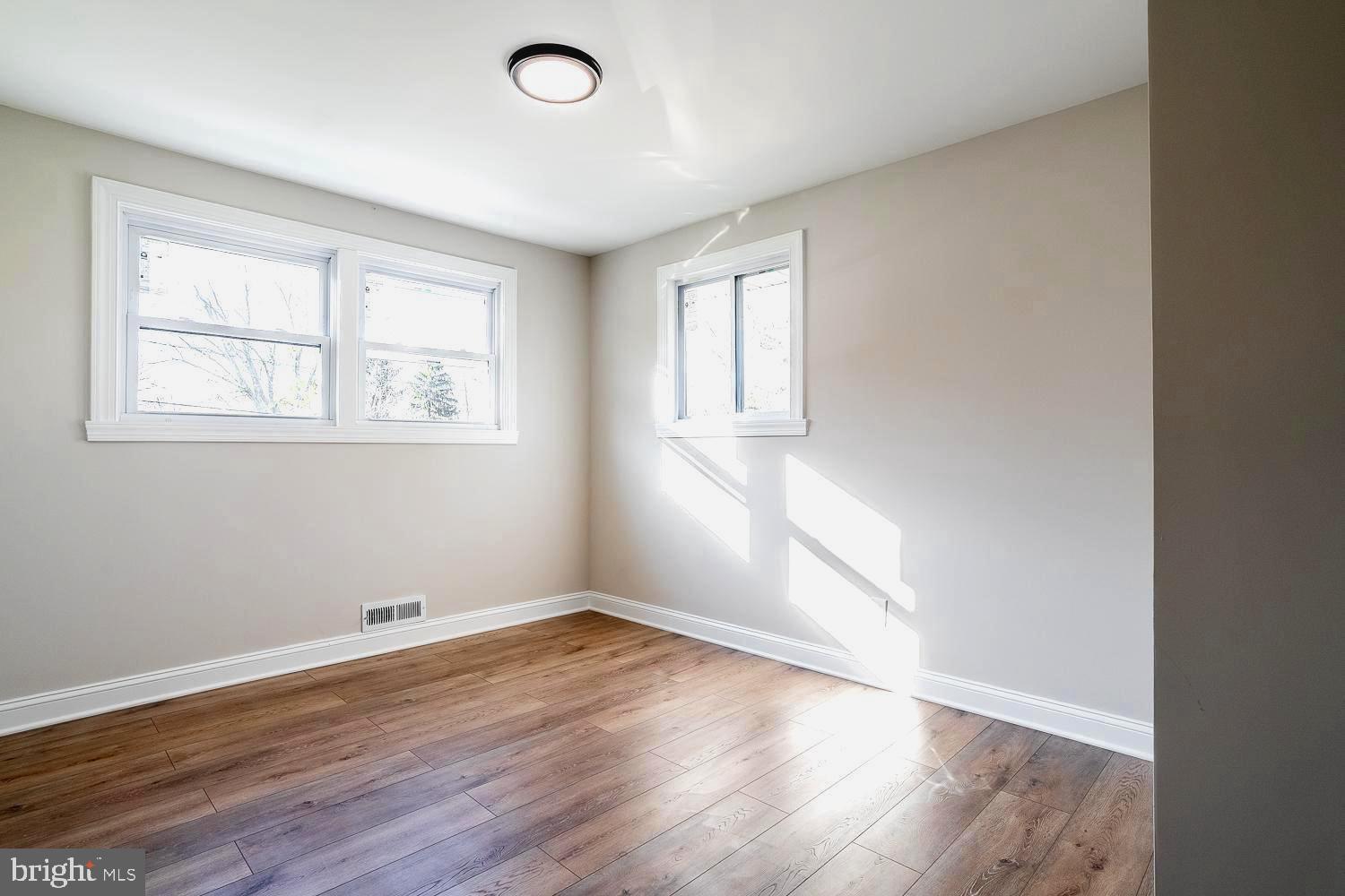 1009 Edgemoor Road Cherry Hill, NJ 08034 - Photo 31 of 49 an empty room with wooden floor and windows