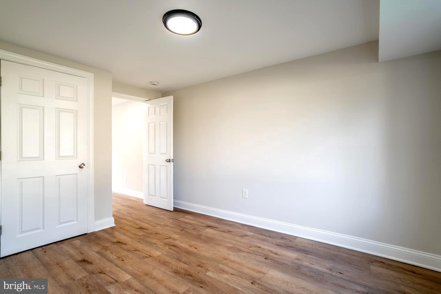 1009 Edgemoor Road Cherry Hill, NJ 08034 - Photo 9 of 49 an empty room with wooden floor and windows