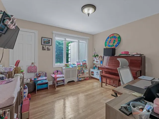 a bedroom with furniture and a window
