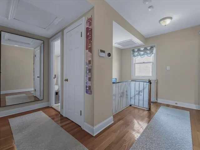 a bedroom with a large bed chandelier and a window