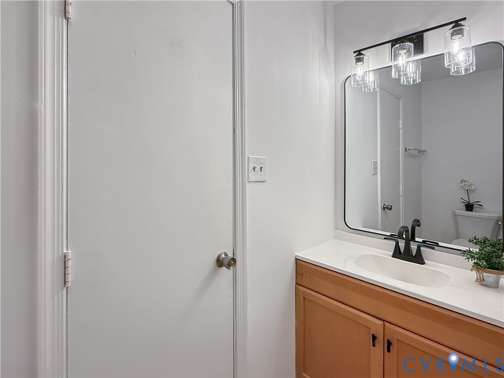 3203 Roland View Terrace Chester, VA 23831 - Photo 14 of 19 Wood-finish vanity with a white countertop and und