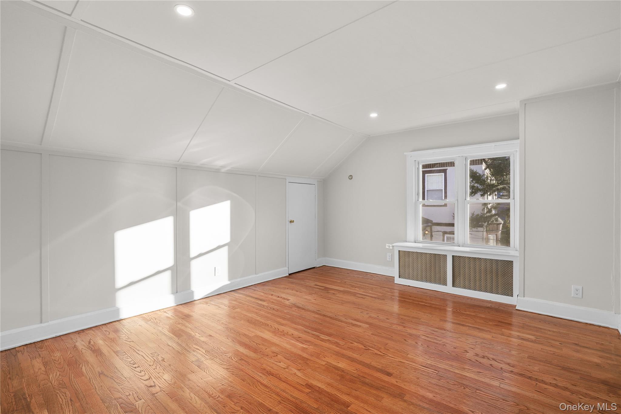 8 Virginia Avenue, Unit 1 Dobbs Ferry, NY 10522 - Photo 11 of 15 Bonus room with radiator, vaulted ceiling, light wood finished floors, and recessed lighting