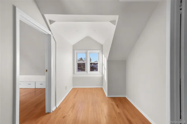 a view of hallway with wooden floor