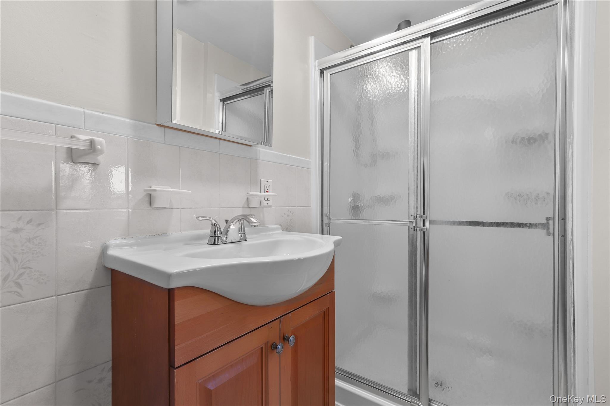 8 Virginia Avenue, Unit 1 Dobbs Ferry, NY 10522 - Photo 16 of 16 a bathroom with a sink and mirror
