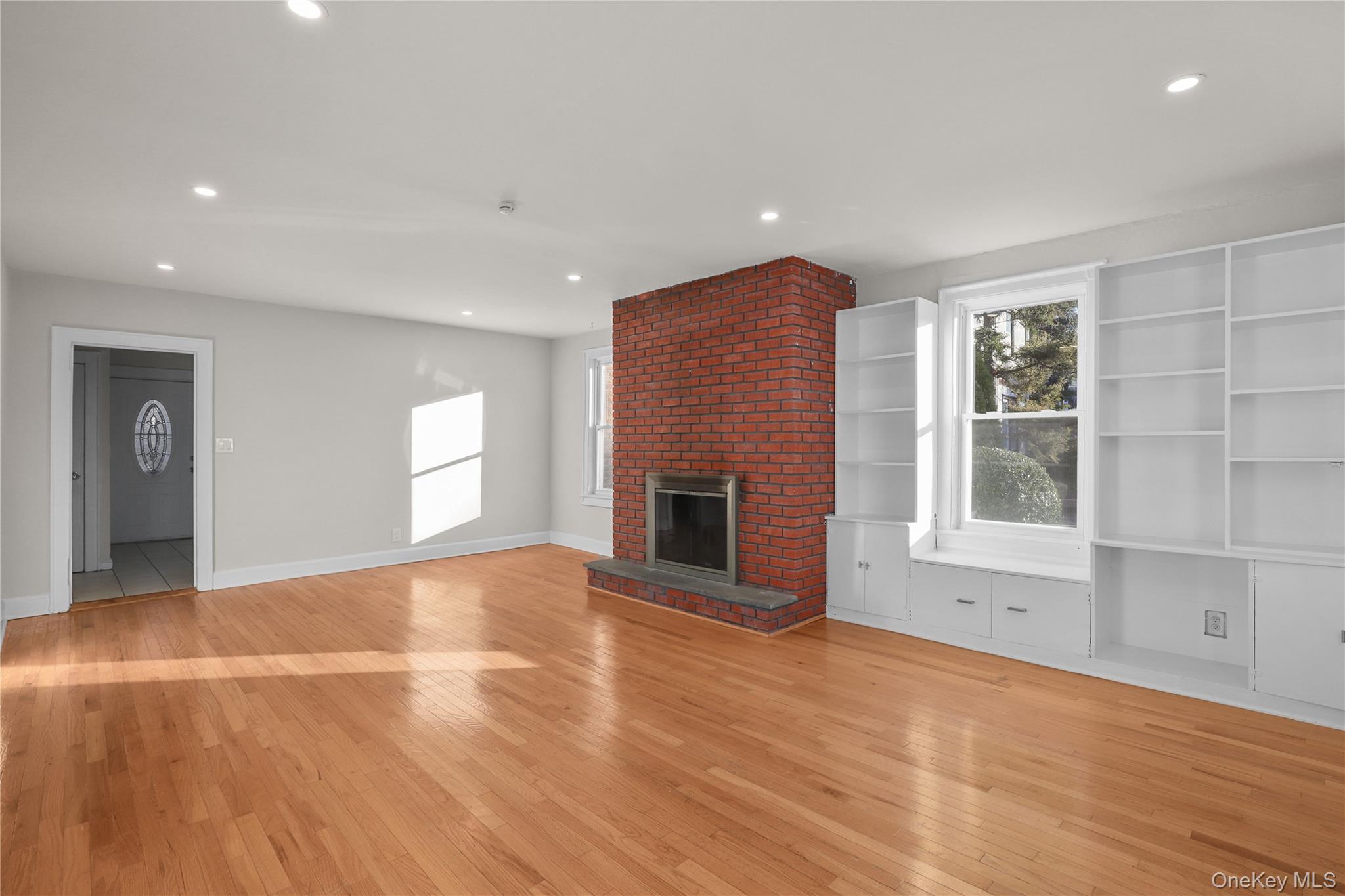 8 Virginia Avenue, Unit 1 Dobbs Ferry, NY 10522 - Photo 4 of 15 Unfurnished living room featuring a fireplace, light wood finished floors, and recessed lighting
