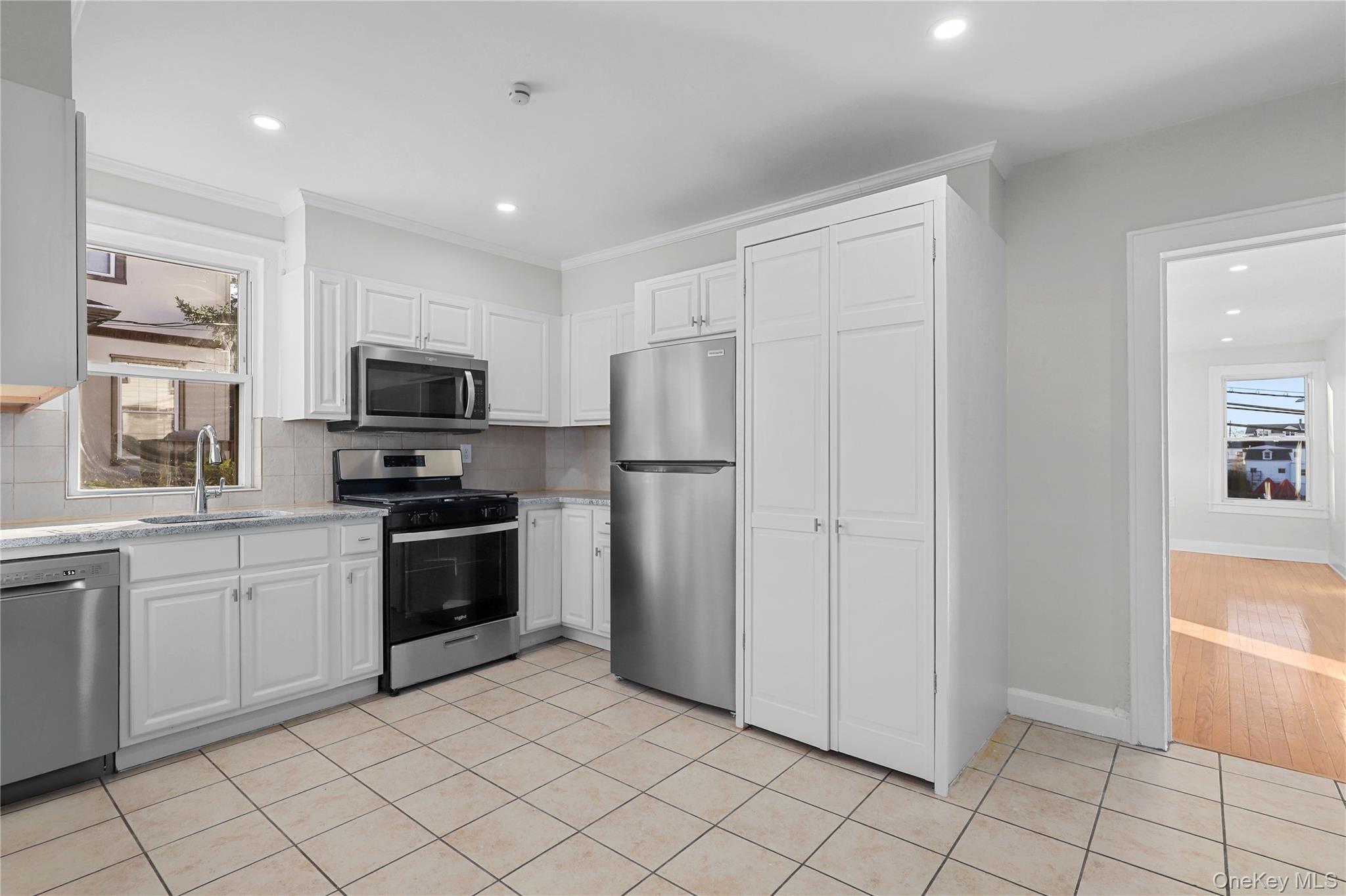 8 Virginia Avenue, Unit 1 Dobbs Ferry, NY 10522 - Photo 4 of 16 a kitchen with stainless steel appliances granite countertop a refrigerator and a sink