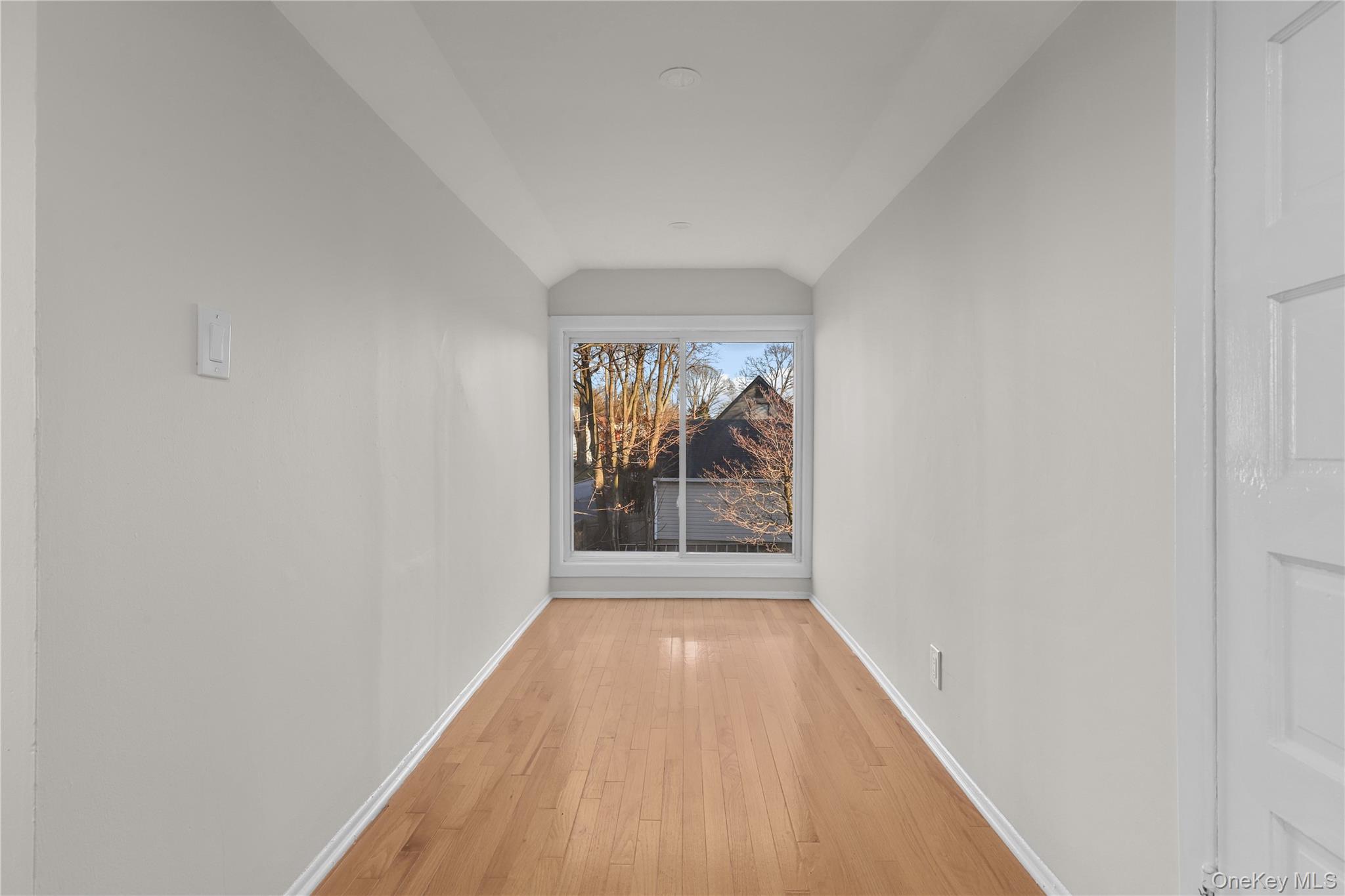 8 Virginia Avenue, Unit 1 Dobbs Ferry, NY 10522 - Photo 8 of 15 Hallway featuring hardwood / wood-style flooring and vaulted ceiling