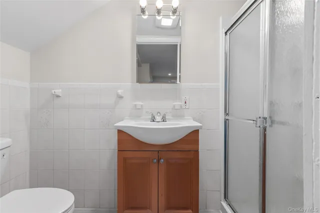 a bathroom with a sink a toilet and mirror
