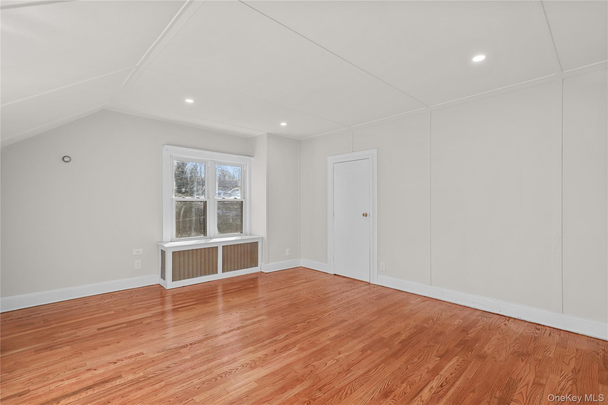 8 Virginia Avenue, Unit 1 Dobbs Ferry, NY 10522 - Photo 10 of 15 Bonus room featuring radiator, light wood-style floors, and recessed lighting