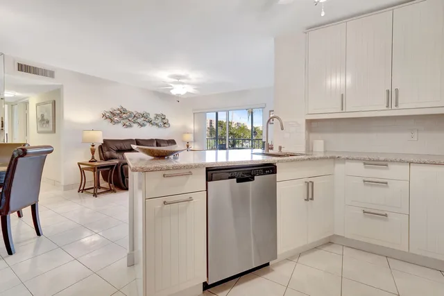 a kitchen with cabinets and chairs