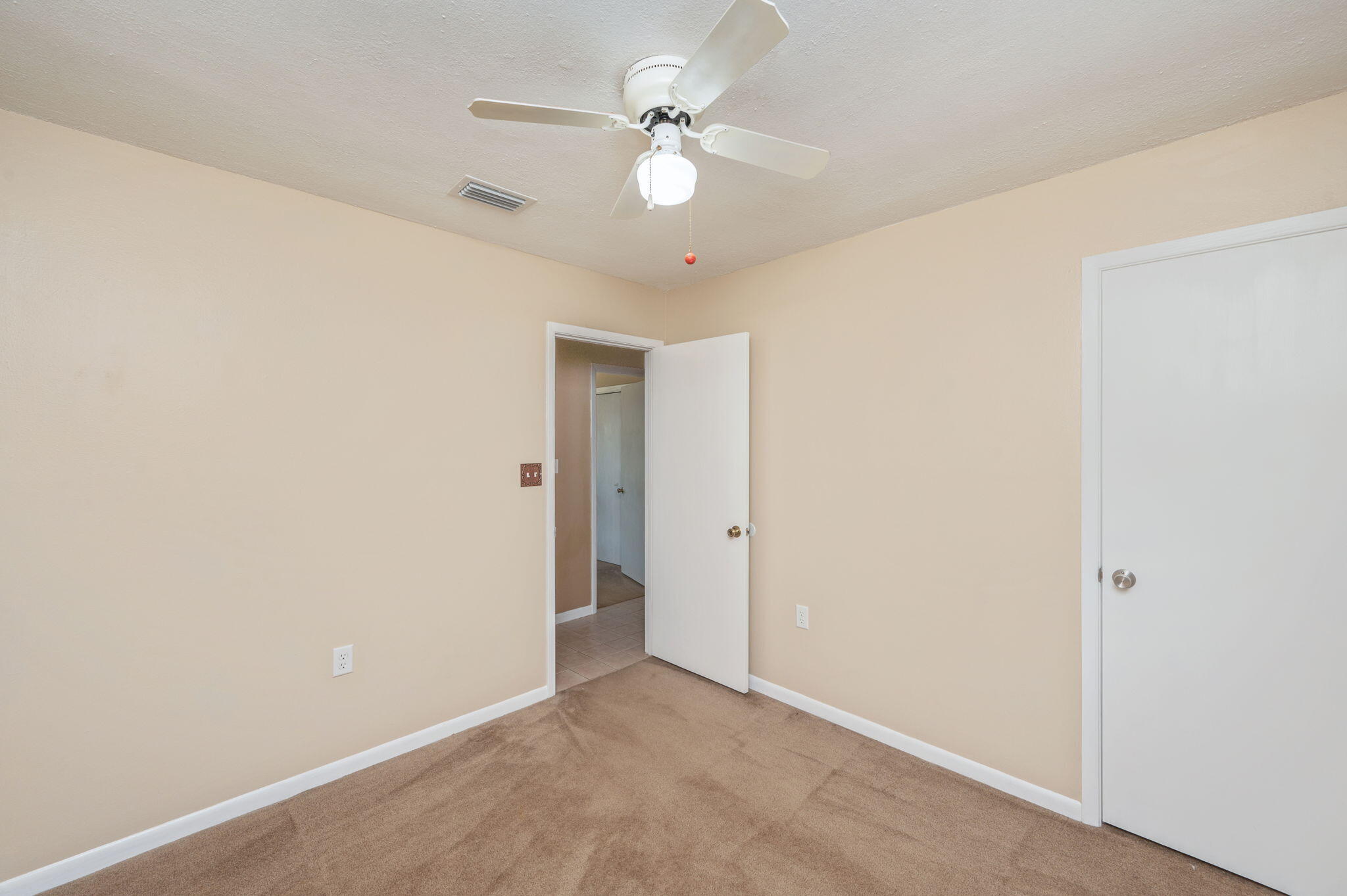 106 Campbell Street Crestview, FL 32536 - Photo 13 of 30 an empty room with a ceiling fan and a window