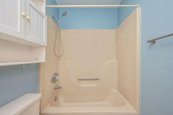 a bathroom with a bathtub and a shower
