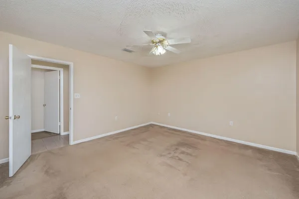 a view of an empty room with a fan