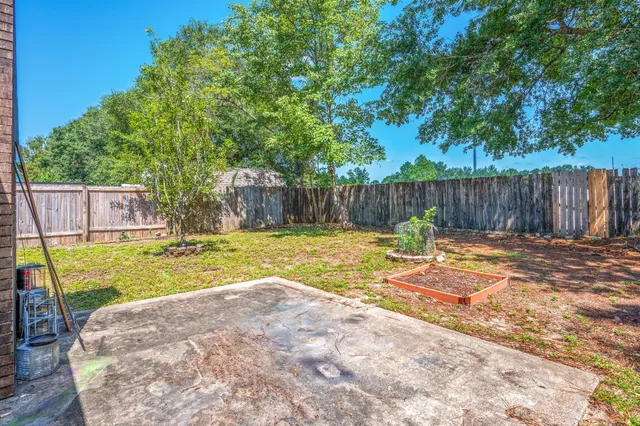 a swimming pool with outdoor seating and yard