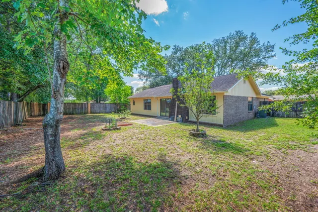 a backyard of a house with table and chairs