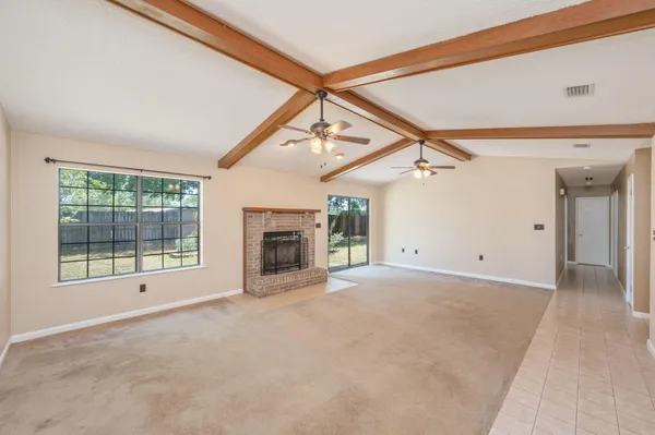 a view of a livingroom with an empty space and a fireplace