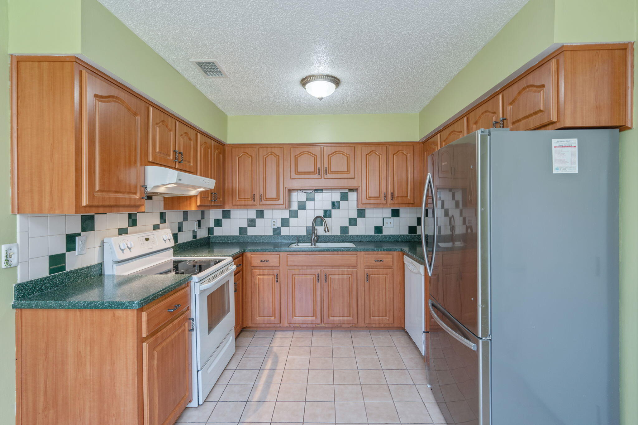 106 Campbell Street Crestview, FL 32536 - Photo 8 of 30 a kitchen with stainless steel appliances granite countertop a refrigerator and a sink