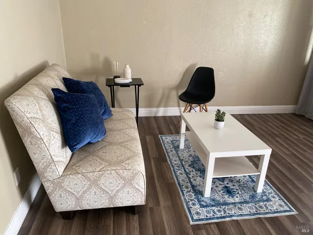 a living room with wooden floor and furniture
