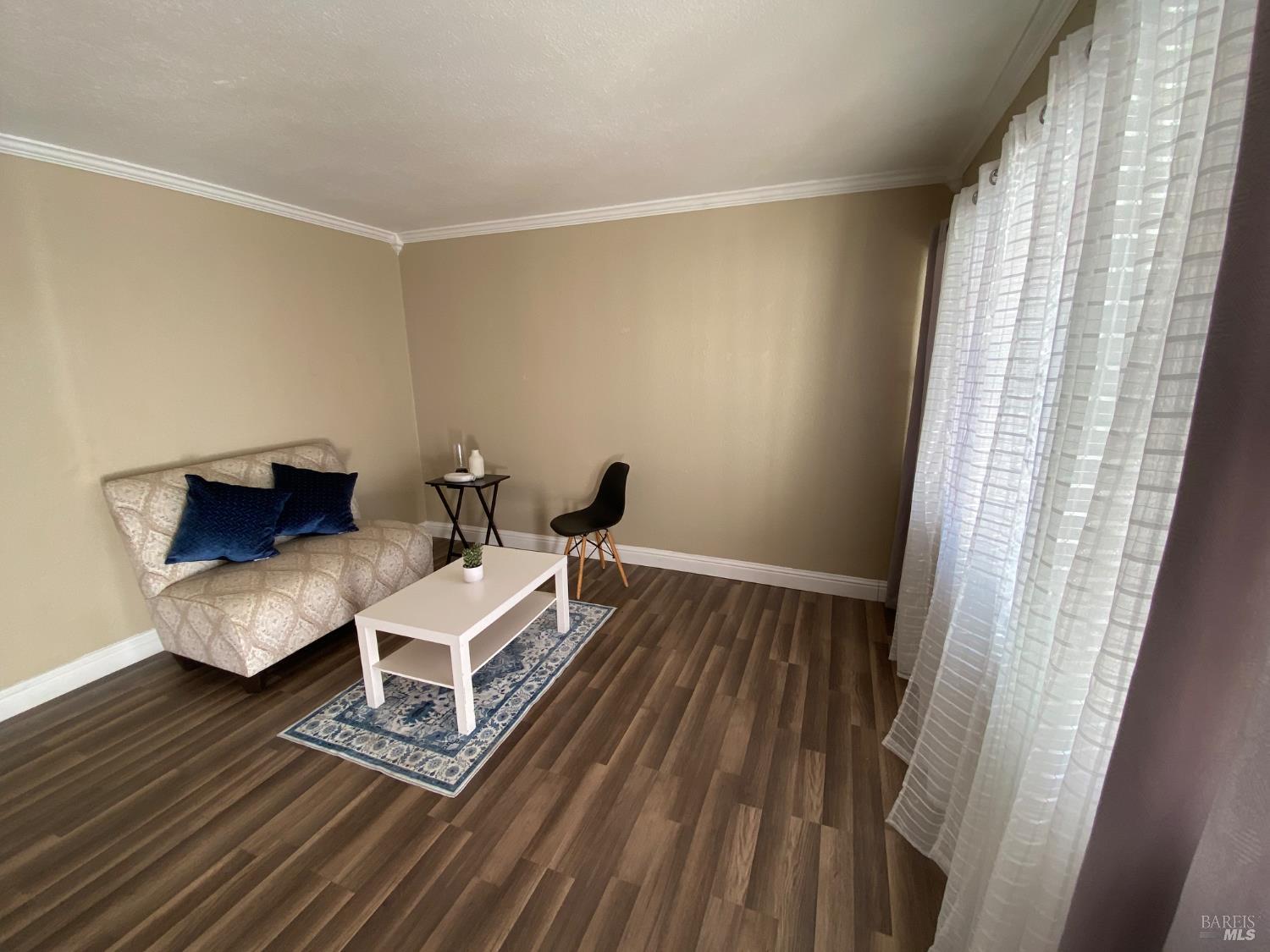 129 Foster Street Vallejo, CA 94591 - Photo 19 of 37 a living room with furniture and a wooden floor