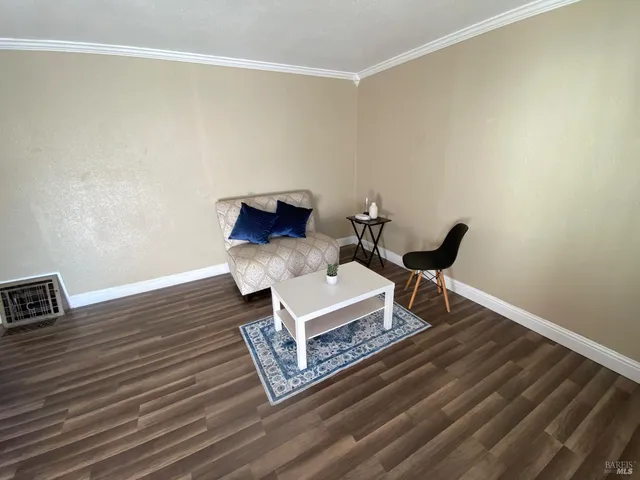 a kitchen with a stove and a wooden floor