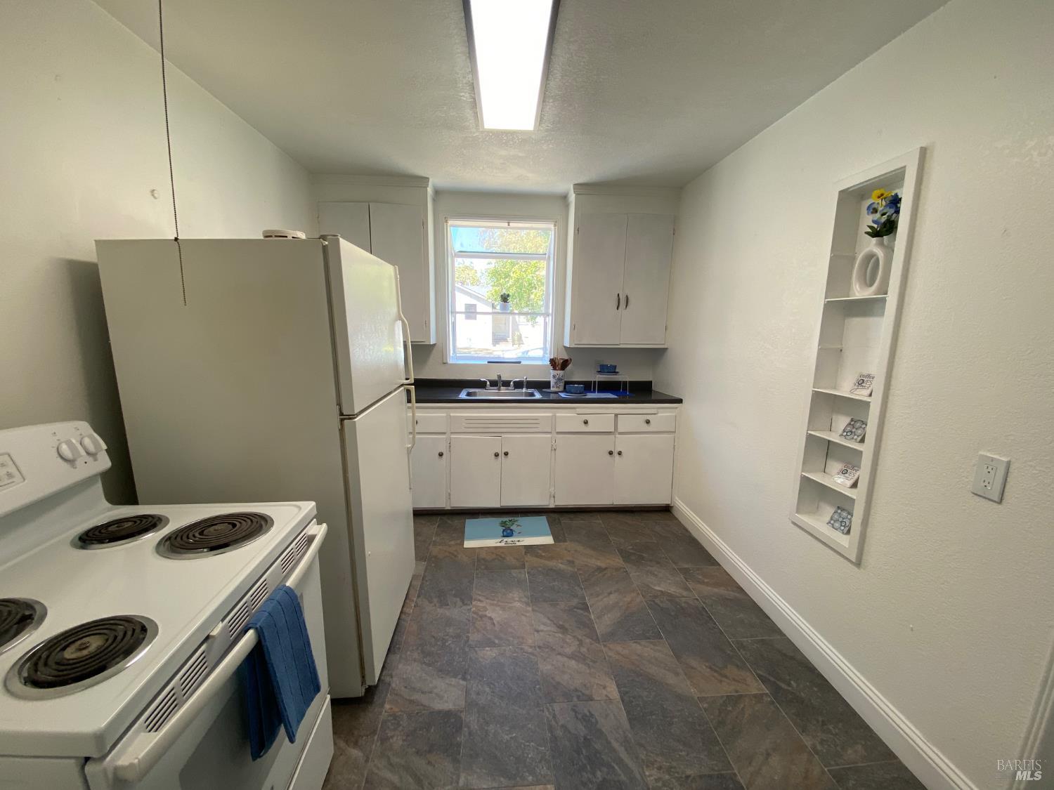 129 Foster Street Vallejo, CA 94591 - Photo 25 of 37 a kitchen with stainless steel appliances a stove a refrigerator and a sink