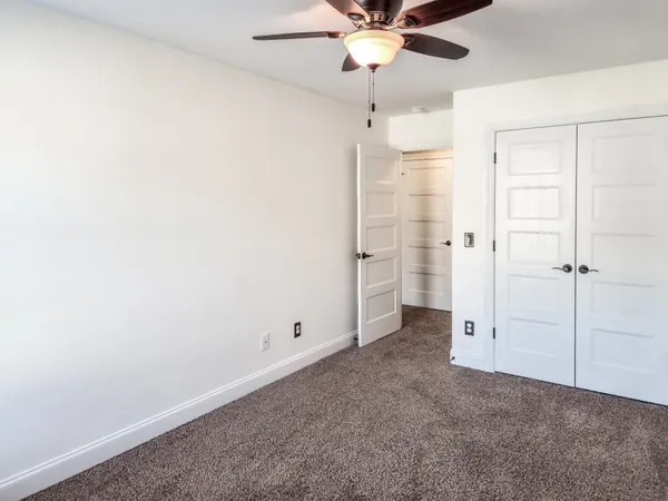 an empty room with a empty space and a ceiling fan