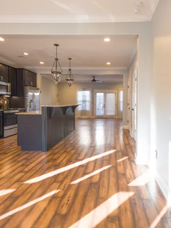 a view of a living room and kitchen with stainless steel appliances