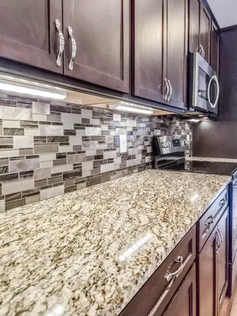 a kitchen with granite countertop stainless steel appliances and cabinets