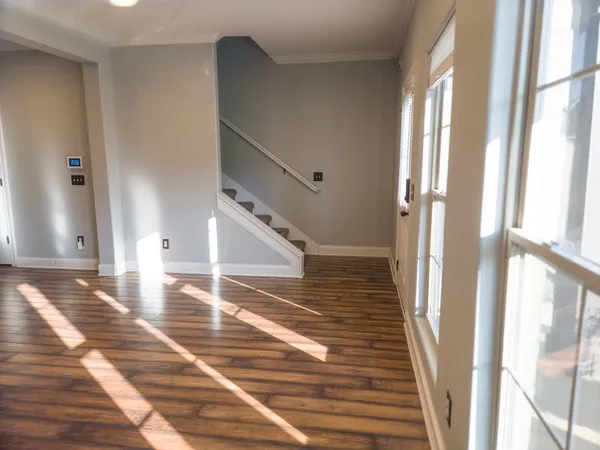 a view of a hallway view with wooden floor and staircase
