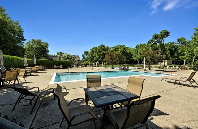 a view of swimming pool with outdoor seating