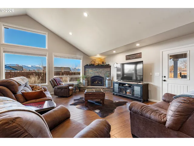 a living room with furniture a fireplace and a flat screen tv