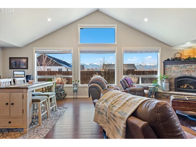 a living room with furniture a fireplace and a large window