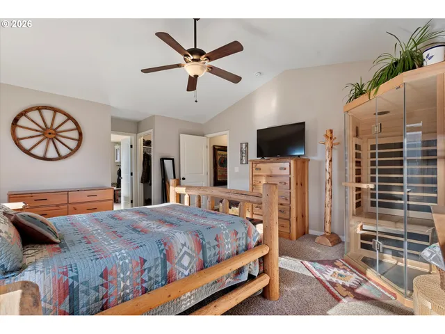 a bedroom with a large bed and a flat screen tv