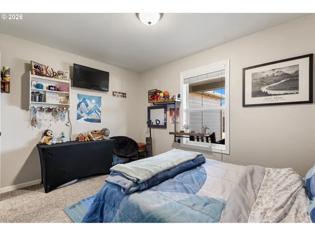 a bedroom with a bed and a couch