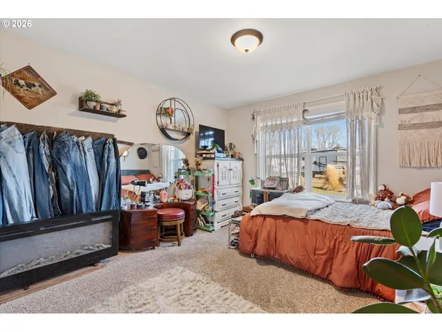 a bedroom with furniture and a window