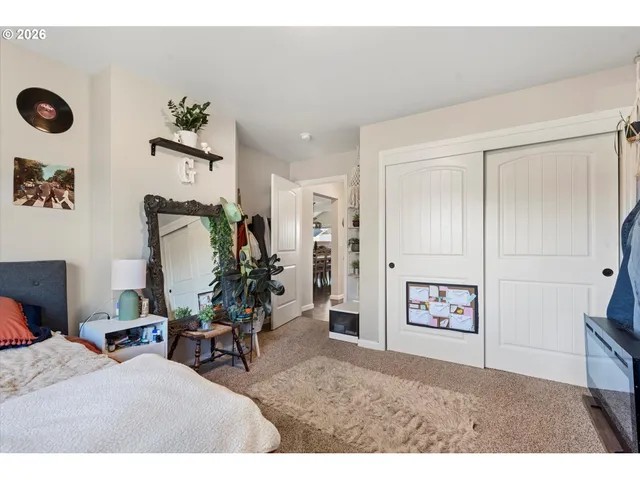 a bedroom with two beds and a chandelier