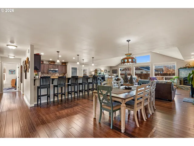 a dining room with furniture and wooden floor