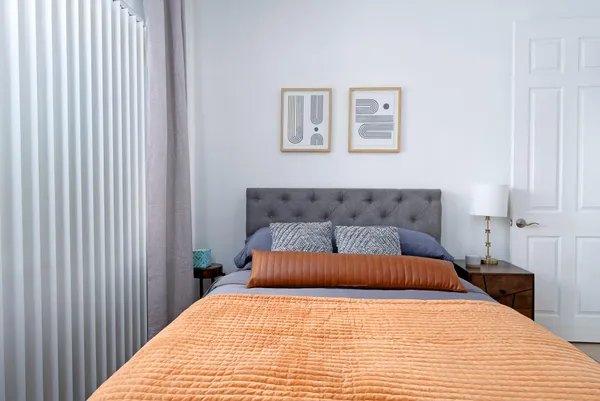 a bedroom with a bed and a window