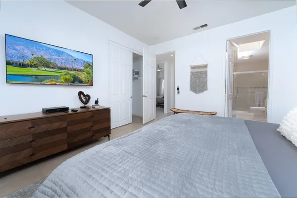 a bed room with furniture and painting on the wall