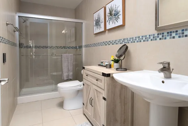 a bathroom with a sink toilet and shower