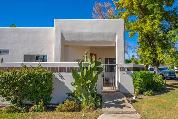 front view of a house with potted plants